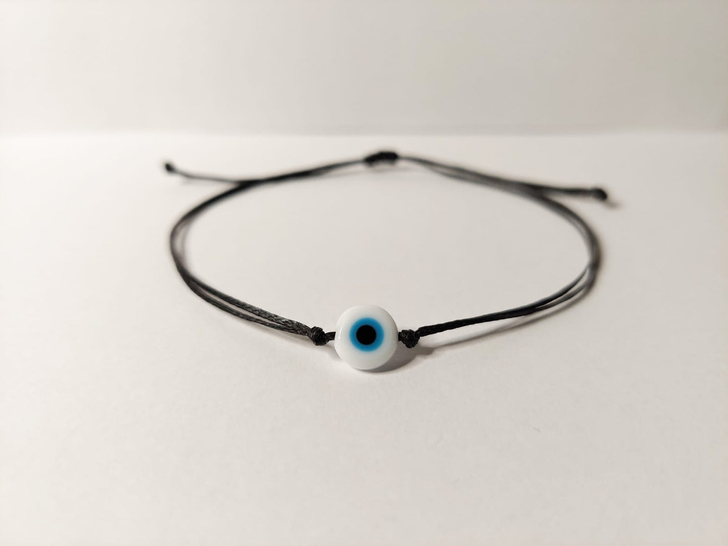 BLACK THREAD WITH WHITE EVIL EYE BRACELET