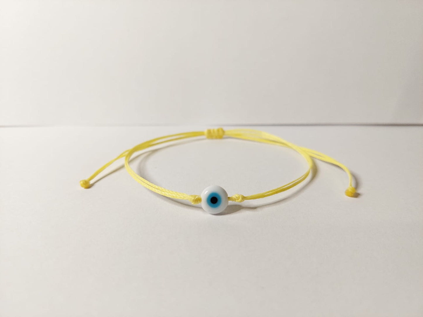 YELLOW THREAD WITH EYE BRACELET