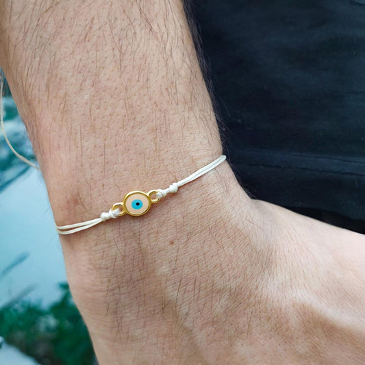 BEIGE THREAD WITH PEACH-GOLD EVIL EYE BRACELET