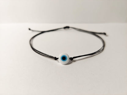BLACK THREAD WITH WHITE EVIL EYE BRACELET