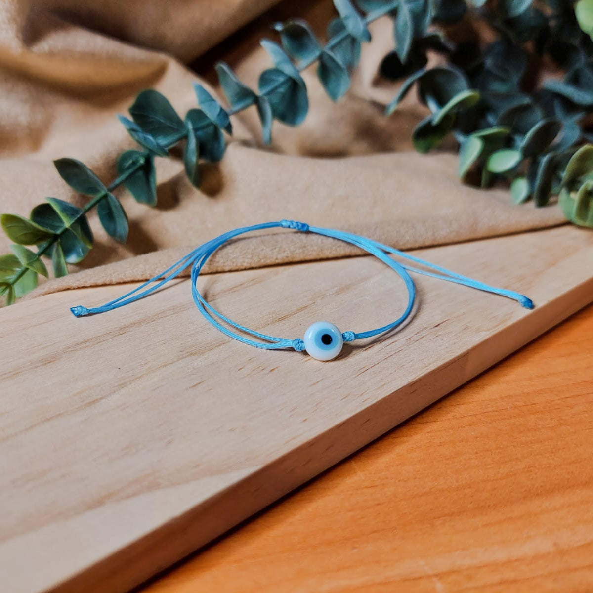 BABY BLUE THREAD WITH WHITE EVIL EYE BRACELET