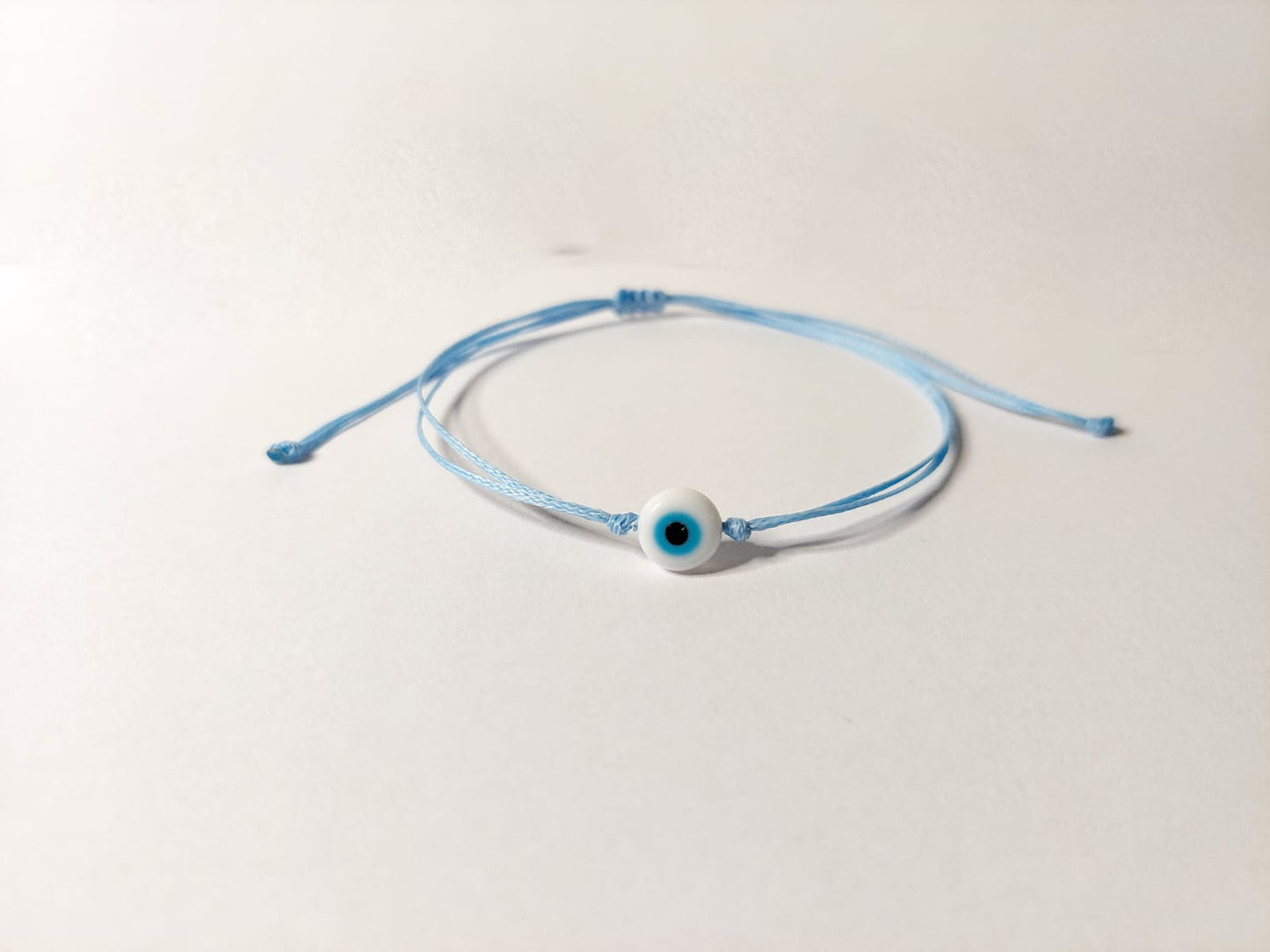 BABY BLUE THREAD WITH WHITE EVIL EYE BRACELET