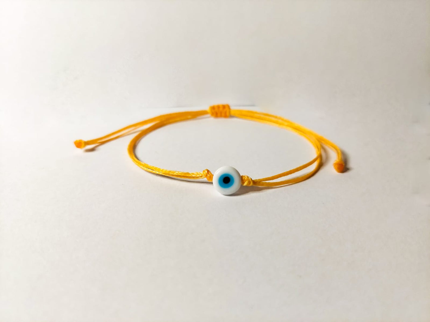 ORANGE THREAD WITH WHITE EVIL EYE BRACELET