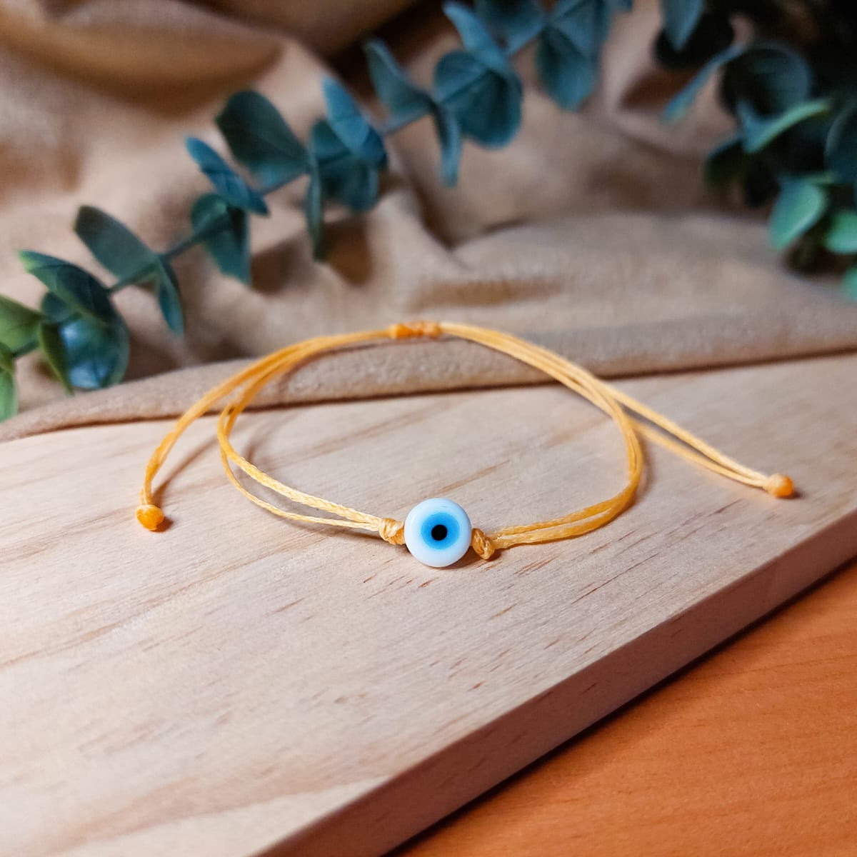 ORANGE THREAD WITH WHITE EVIL EYE BRACELET